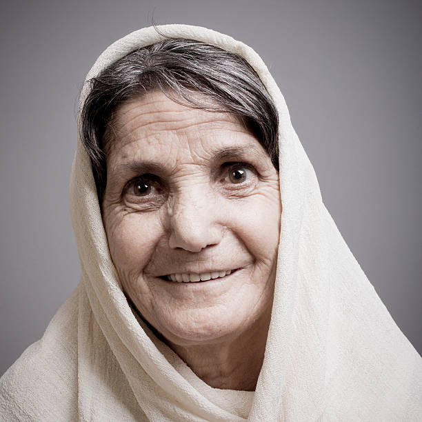 portrait of happy elder woman with headscarf in the village, east European Balkans old woman outdoors