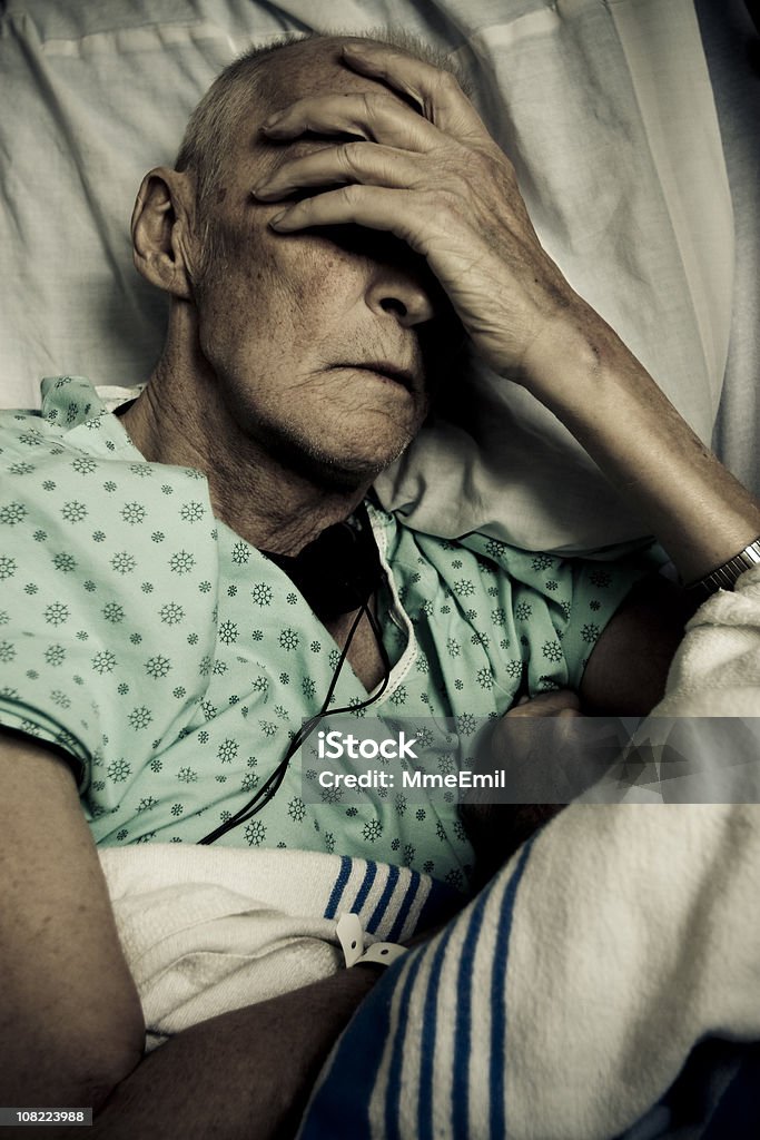 Tired and Sick Senior Man Lying in Hospital Bed  Cancer - Illness Stock Photo