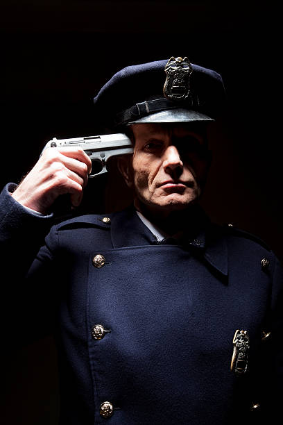 Mature police officer aiming with short gun