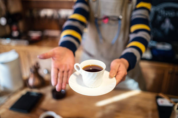 istock Barista holding a cup of coffee 1082242924