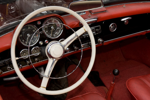 Interior view of old vintage car. View on dashboard of classic car.