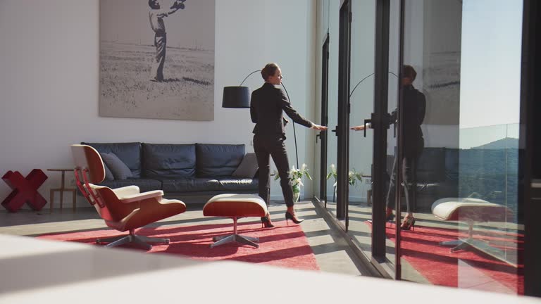 Businesswoman with mobile phone at modern home