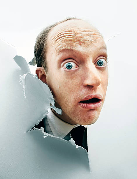 ciekawski człowiek szturchać głowę przez uszkodzony płótna - bizarre people eccentric human face zdjęcia i obrazy z banku zdjęć
