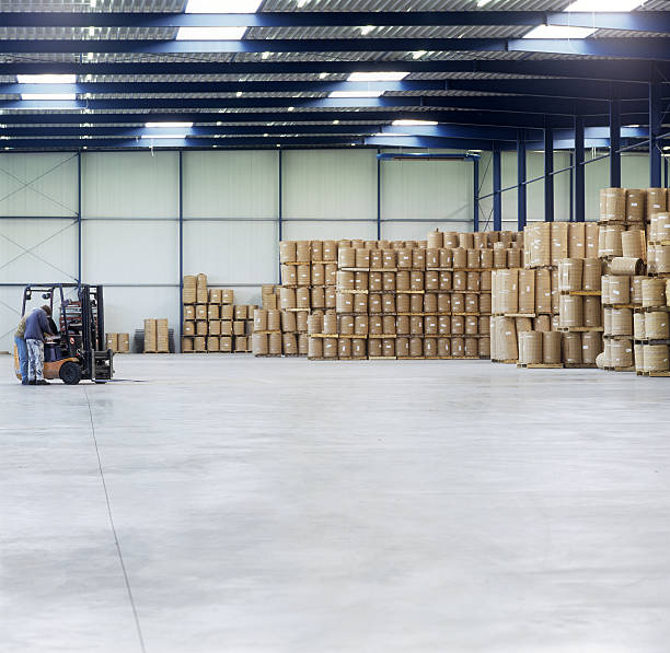 istock Man Near Forklift in Warehouse with StorageBarrels 108224639