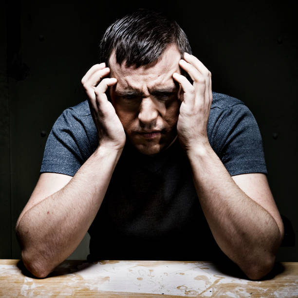 istock Man Holding Head in Hands, Low Key 108224660