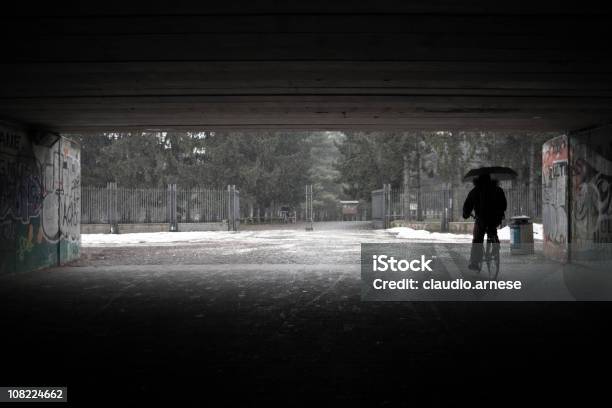 Persona Sotto Il Ponte Bicicletta Di Equitazione Durante Linverno - Fotografie stock e altre immagini di Bicicletta