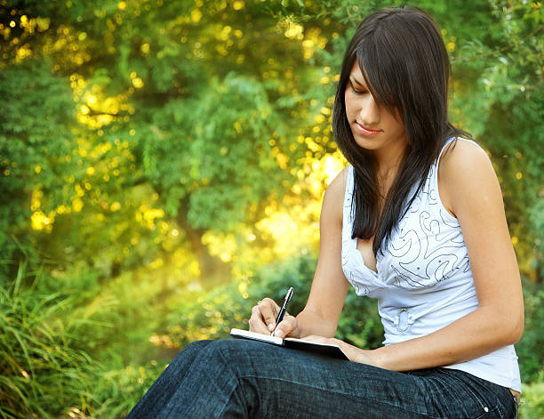 istock Young Woman Writing in Journal Outside 108225385