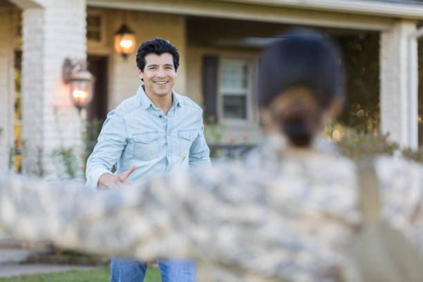 istock Husband greets military wife at her homecoming 1082253916