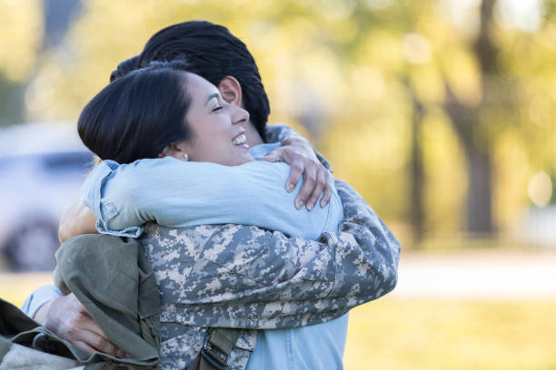 istock Military wife embraces husband 1082253938