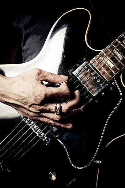 istock Close-up of Hands Playing Electric Guitar 108225450