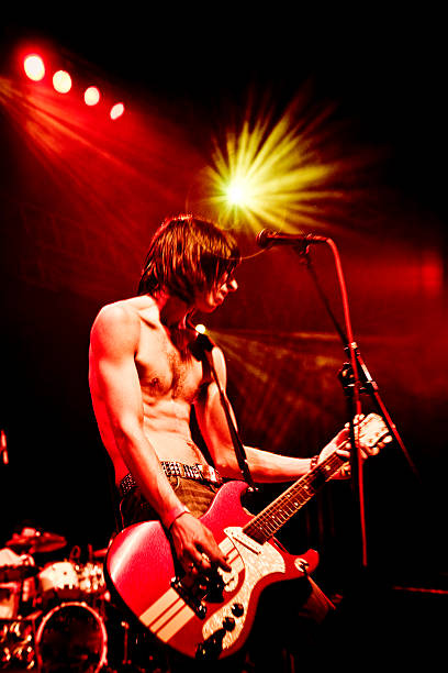 istock Young Man Playing Guitar on Stage at Concert 108225638