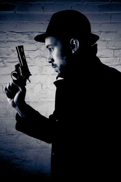 istock Young Man Holding Handgun, Low Key Toned 108225856