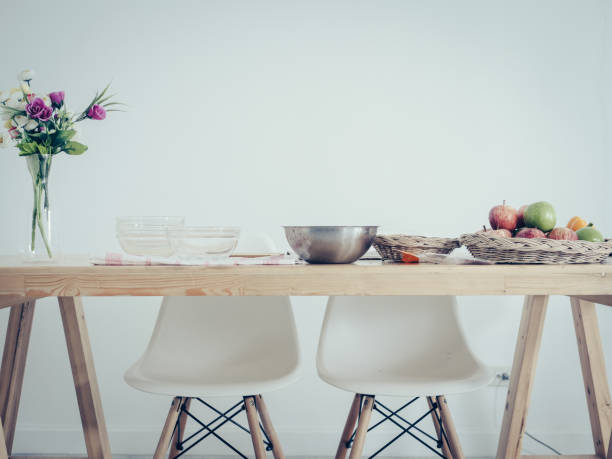 istock Fruits tray, tablet and orange juice on table with white wall. 1082259418