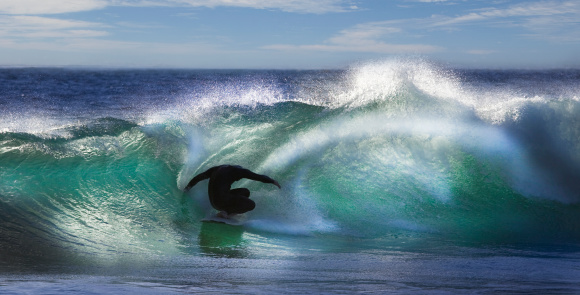 Nazare, Portugal - December, 19, 2023: Surfer riding big waves in Nazare, Portugal. Big waves of Atlantic ocean in winter season