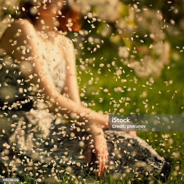 Young Woman In Garden With Petals Stock Photo - Download Image Now - Falling, Petal, Adult