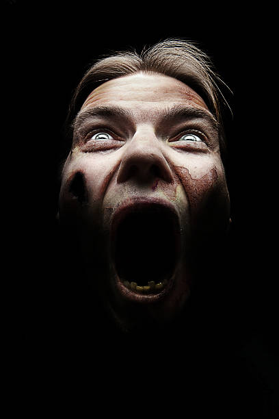 A horror image of a female covered in blood screaming Rotten zombi screaming shouting stock pictures, royalty-free photos & images