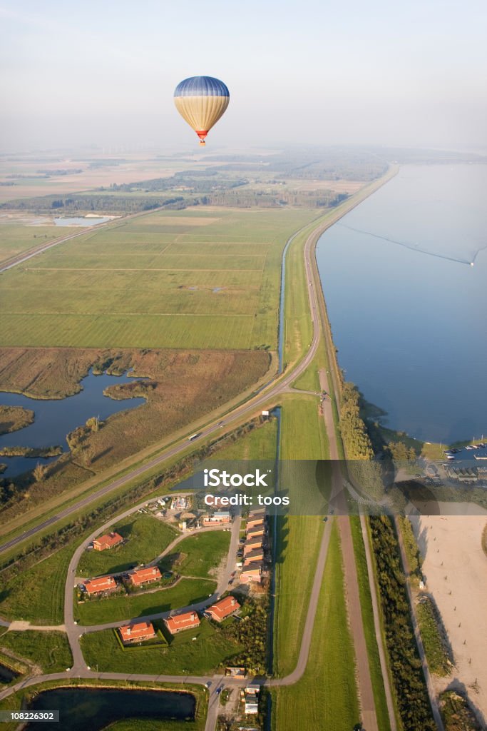 Hot Air Balloon floating over a scenic Dutch polder landscape  Hot Air Balloon Stock Photo