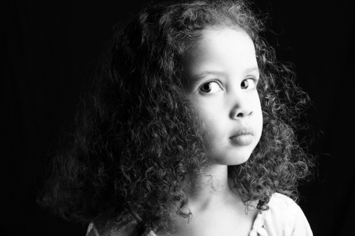 Black and white portrait of serious young girl.