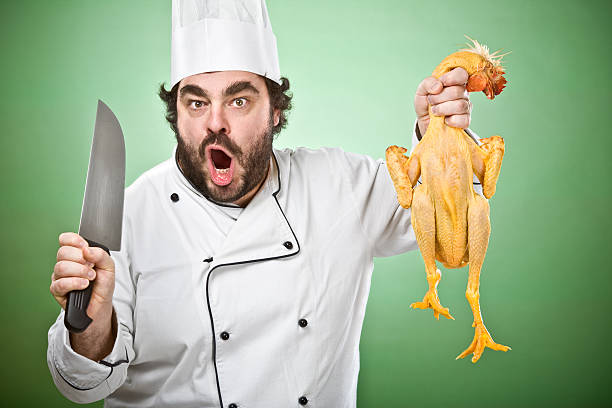 Chef watches onion between his fingers.