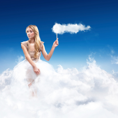 Young Woman Sitting in the Sky on Clouds