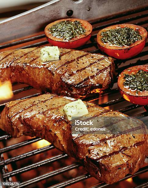 Steaks And Tomatoes On Barbeque Grill Stock Photo - Download Image Now - Barbecue Grill, Steak, Butter