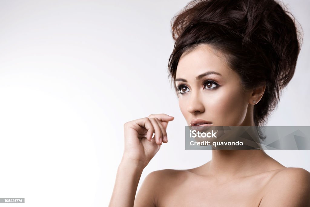Beautiful Brunette Young Woman Head Shot on White, Copy Space Gorgeous female model looking sideways and up. Copy space to left. CLICK FOR SIMILAR IMAGES AND LIGHTBOX WITH MORE BEAUTIFUL WOMEN. http://www.quavondo.com/thumbs/IStockLightboxWomen.jpg 20-29 Years Stock Photo