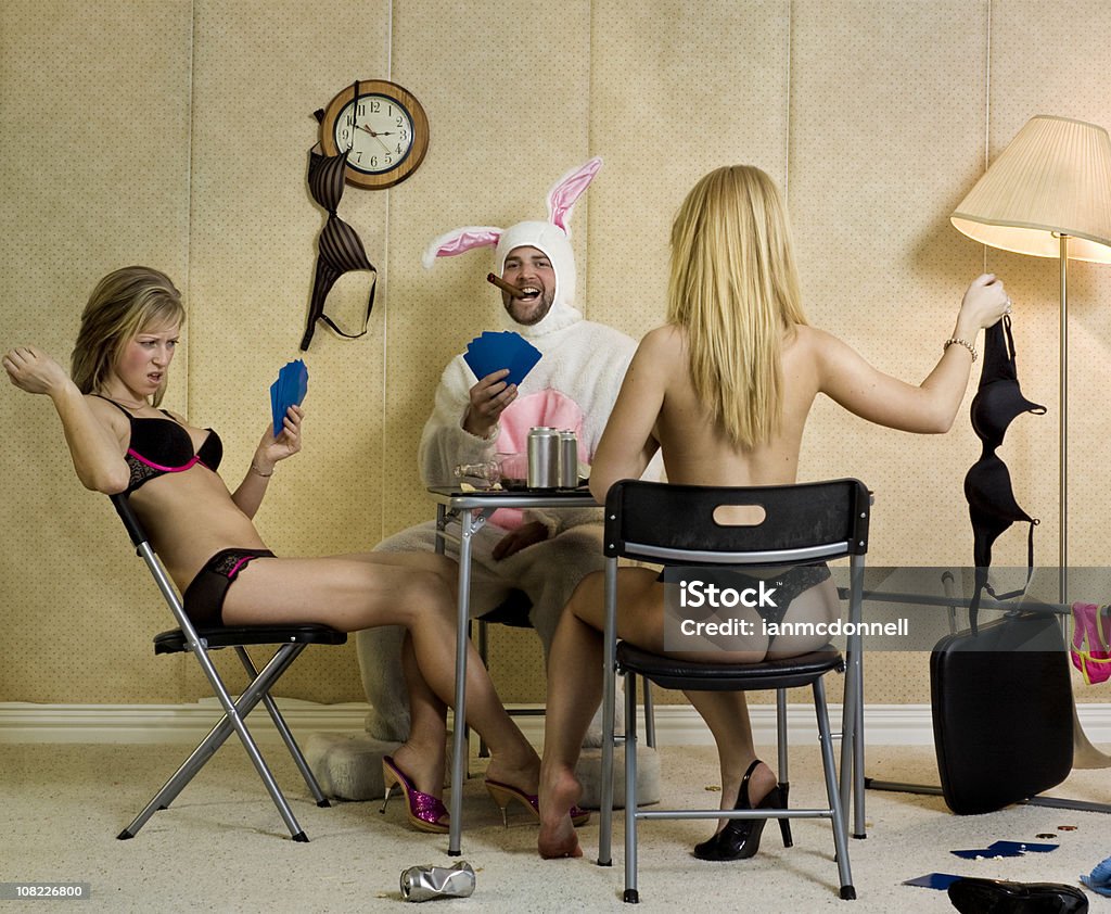 Two Women and Man Playing Strip Poker bunny and two women playing strip poker Easter Stock Photo