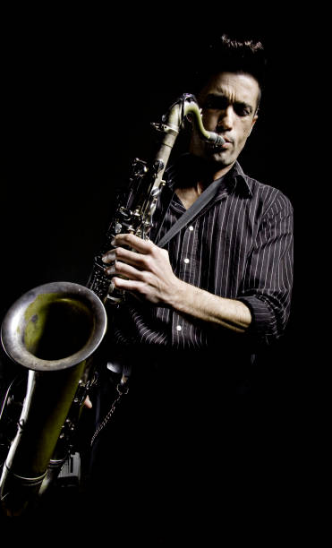 istock Young Man with Greased Hair Playing Saxophone, Low Key 108226838
