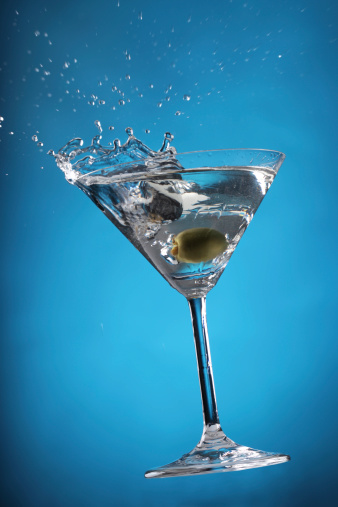 Freeze motion of splashing martini drink in bar. Free space for text