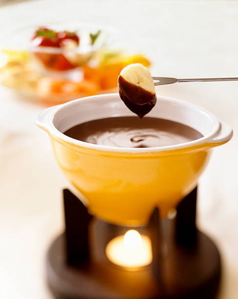 Banana Dipped in Chocolate Fondue stock photo