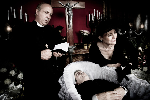 Portrait of a widow and a priest, crying desperately over the death of her husband. 