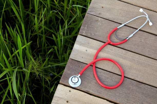 Concept, Doctor or medical volunteers stethoscope red on wood, Concept, Doctor or medical volunteers to visit elderly people in rural Asia rural scene stock pictures, royalty-free photos & images
