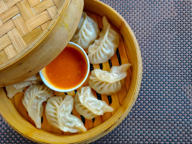 Chicken momo served in a wooden box. Top view