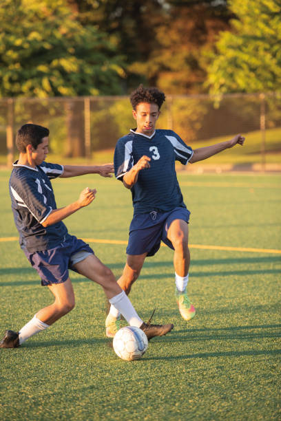 istock Male soccer player dribbling around a defender 1082287318