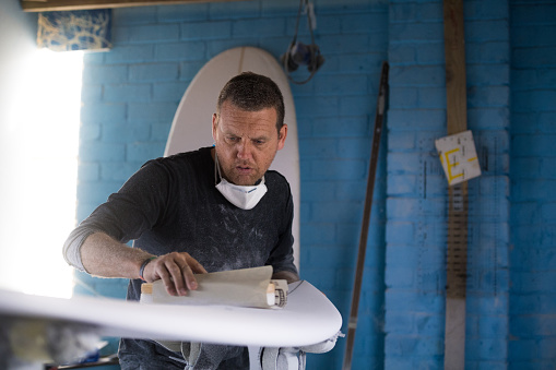 Skilled entrepreneur making custom surfboards