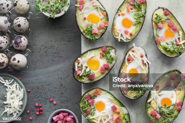 Keto Diet Dish Avocado Boats With Ham Cubes Quail Eggs Cheese And Cress Sprouts Stock Photo - Download Image Now