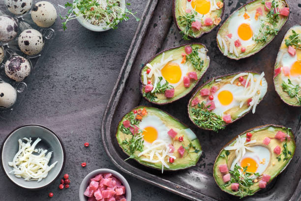 istock Keto diet dish: Avocado boats with ham cubes, quail eggs, cheese and cress sprouts 1082294226