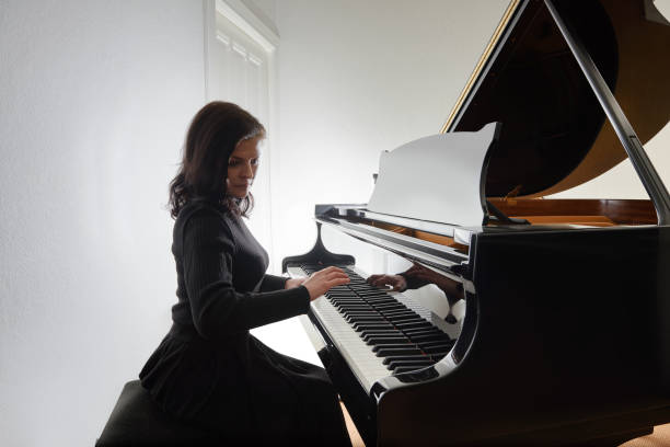 istock Young musician plays the grand piano 1082299480