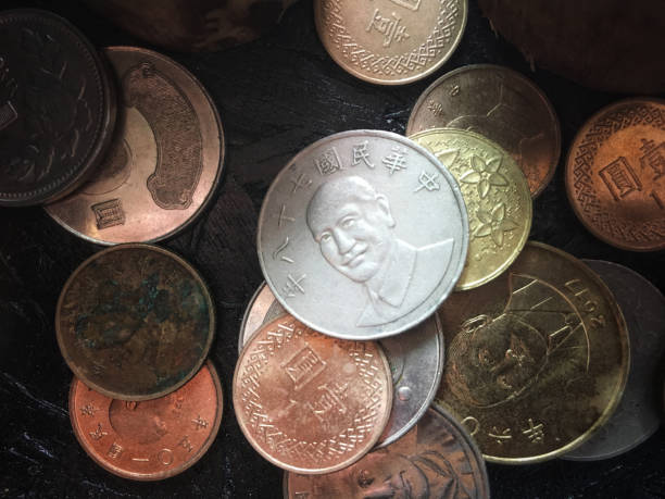 istock Colorful old coin stacking on black wooden table for business and financial reference background 1082299666