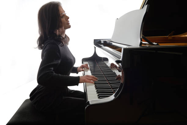 istock Young musician plays the grand piano 1082299714