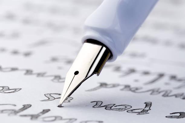 istock yellow fountain pen writing a letter 1082304498