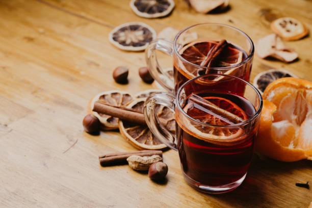 istock Mulled wine in mugs with scarf on wooden table 1082304500