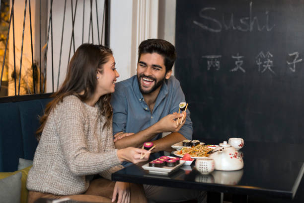 istock Young couple eating sushi 1082316342