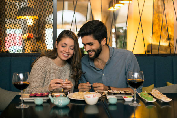 couple in a chinese restaurant - dating restaurant dinner couple imagens e fotografias de stock