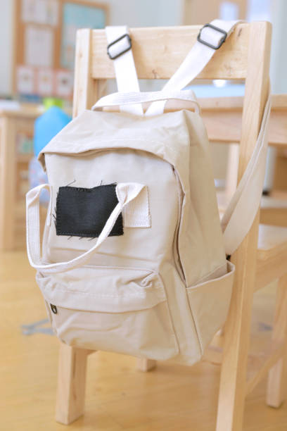 istock beige kid backpack hanging on a chair 1082321902
