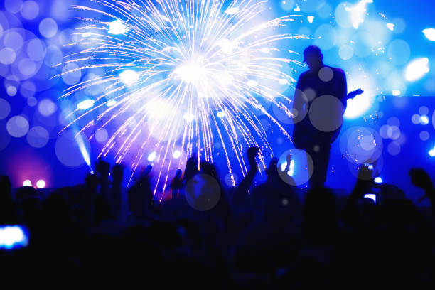 istock New Year concept, cheering crowd and fireworks 1082322110