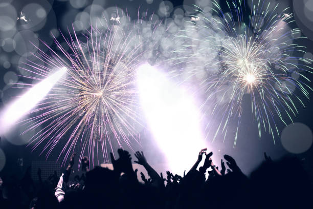 istock New Year concept, cheering crowd and fireworks 1082322114