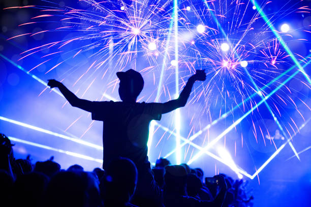 istock New Year concept, cheering crowd and fireworks 1082322116