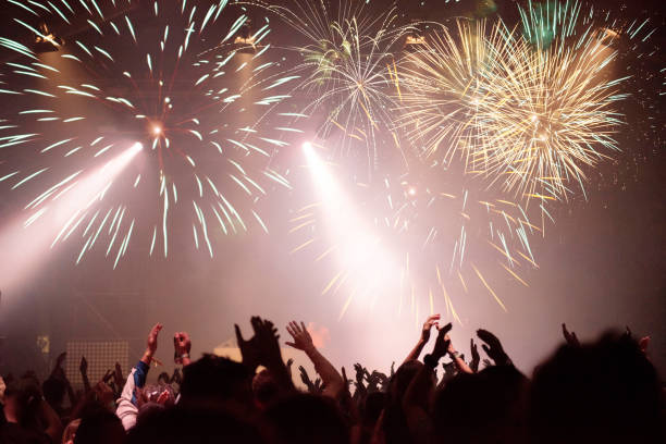 istock New Year concept, cheering crowd and fireworks 1082322124