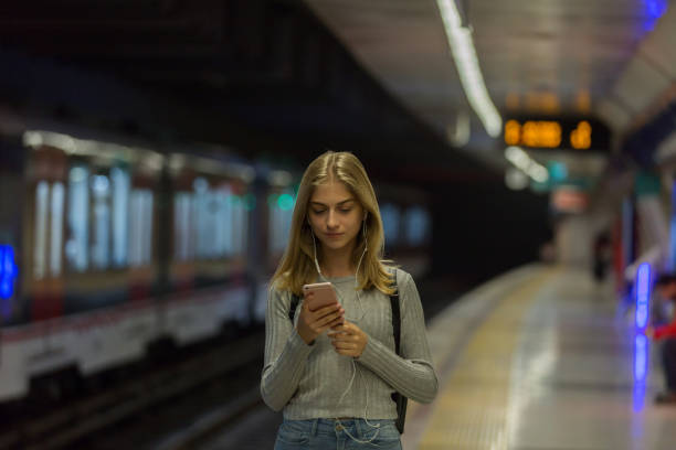 istock Young woman waiting at subway station 1082325864